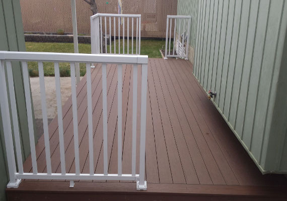 Our composite material decking used for a deck replacement with a metal railing.