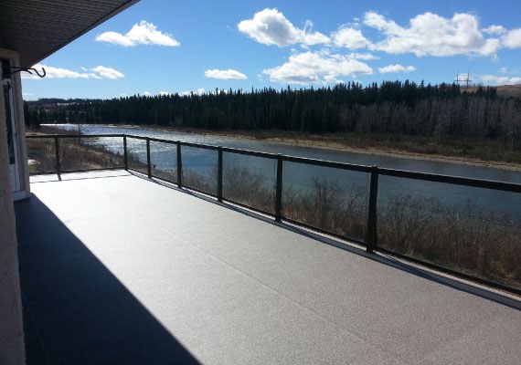Metal and glass railings with our vinyl decking and a river view.
