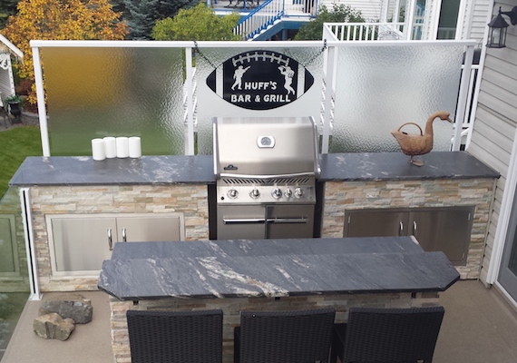 White metal and glass railing, a full service bar & grill with a wind break/privacy wall.