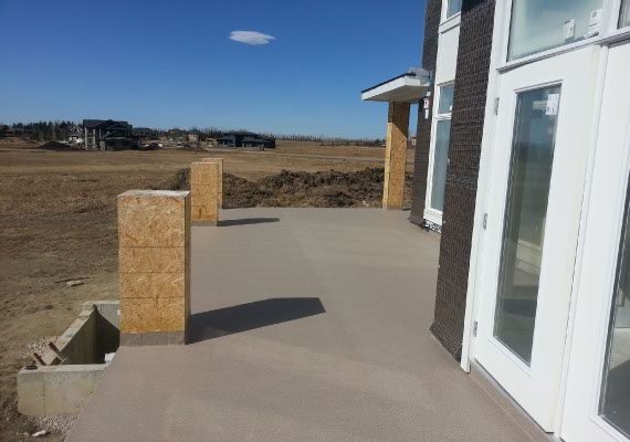 Vinyl decking post installation on a new construction home, railings in progress.
