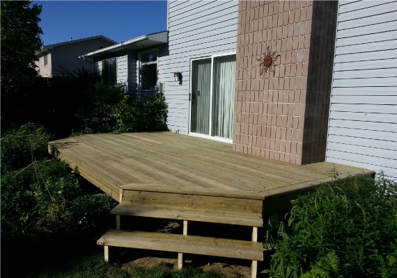 Wooden deck replacement with corner stairs.